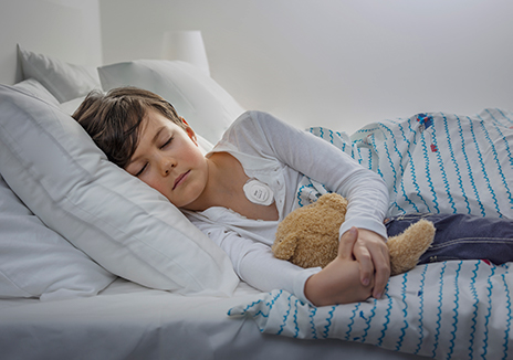 patient laying in bed wearing radius t thermometer